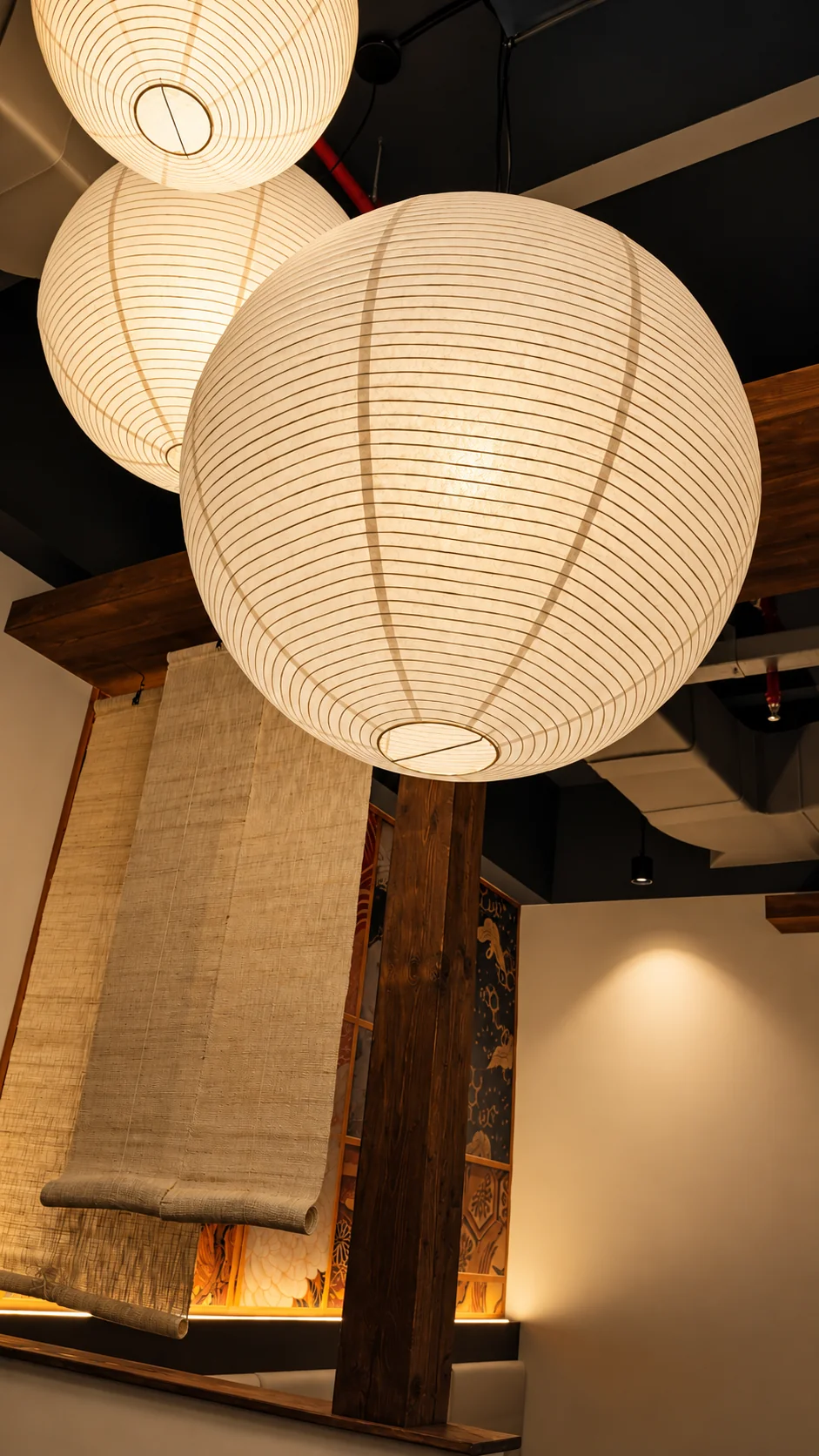 Warm Japanese paper lanterns inside Sumitaba